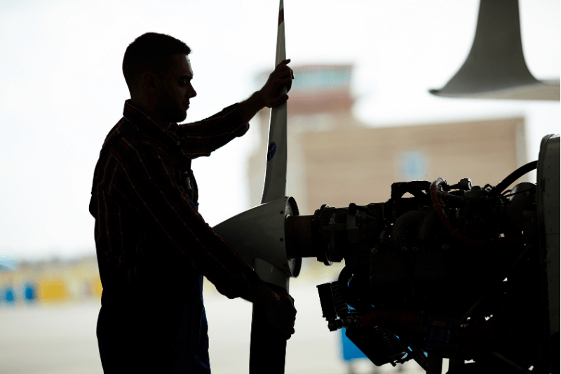An aerospace recruitment hire installs a plane propeller.