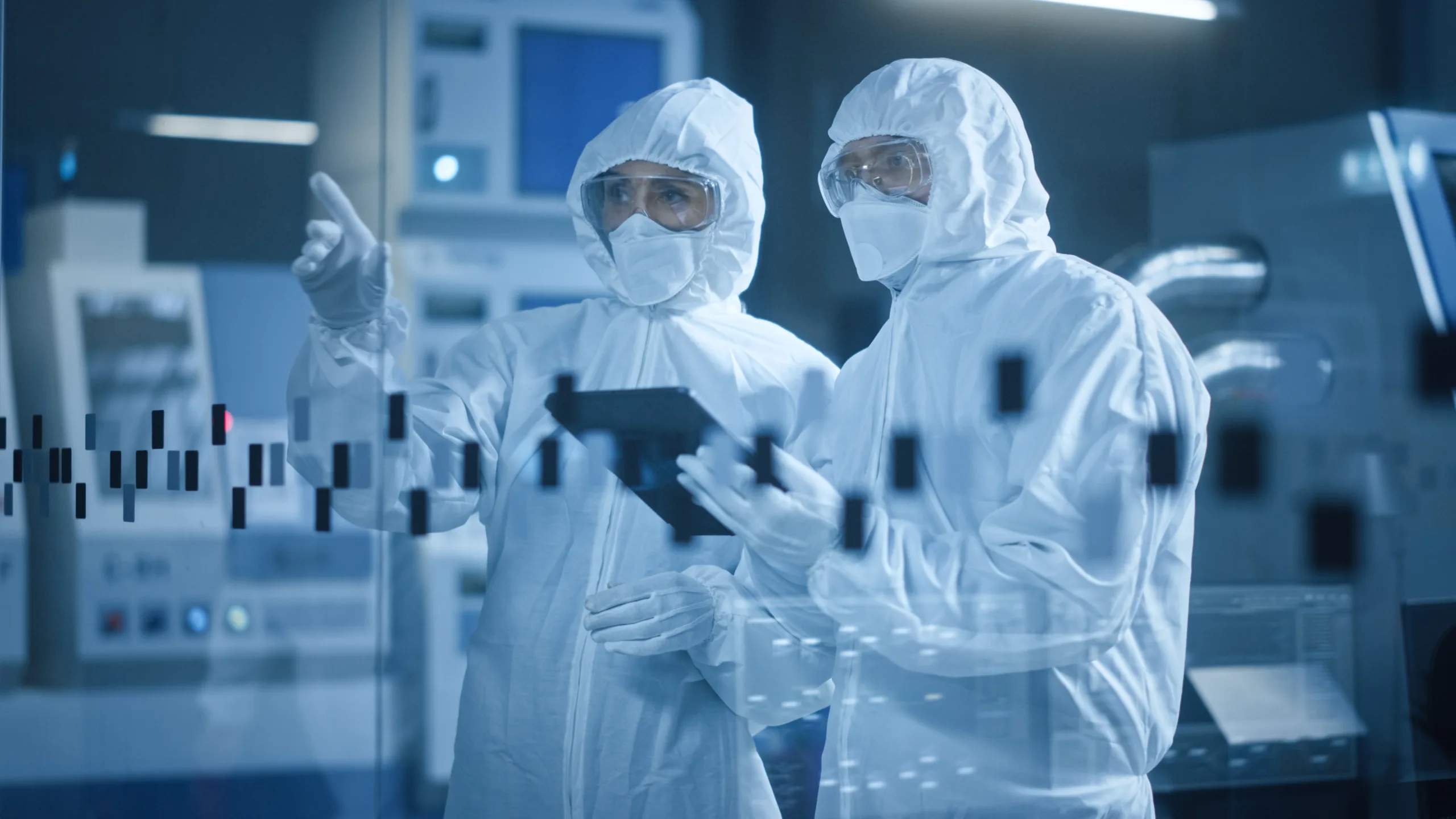 Scalable A semiconductor recruitment hire points and shares expertise with another employee in the lab.