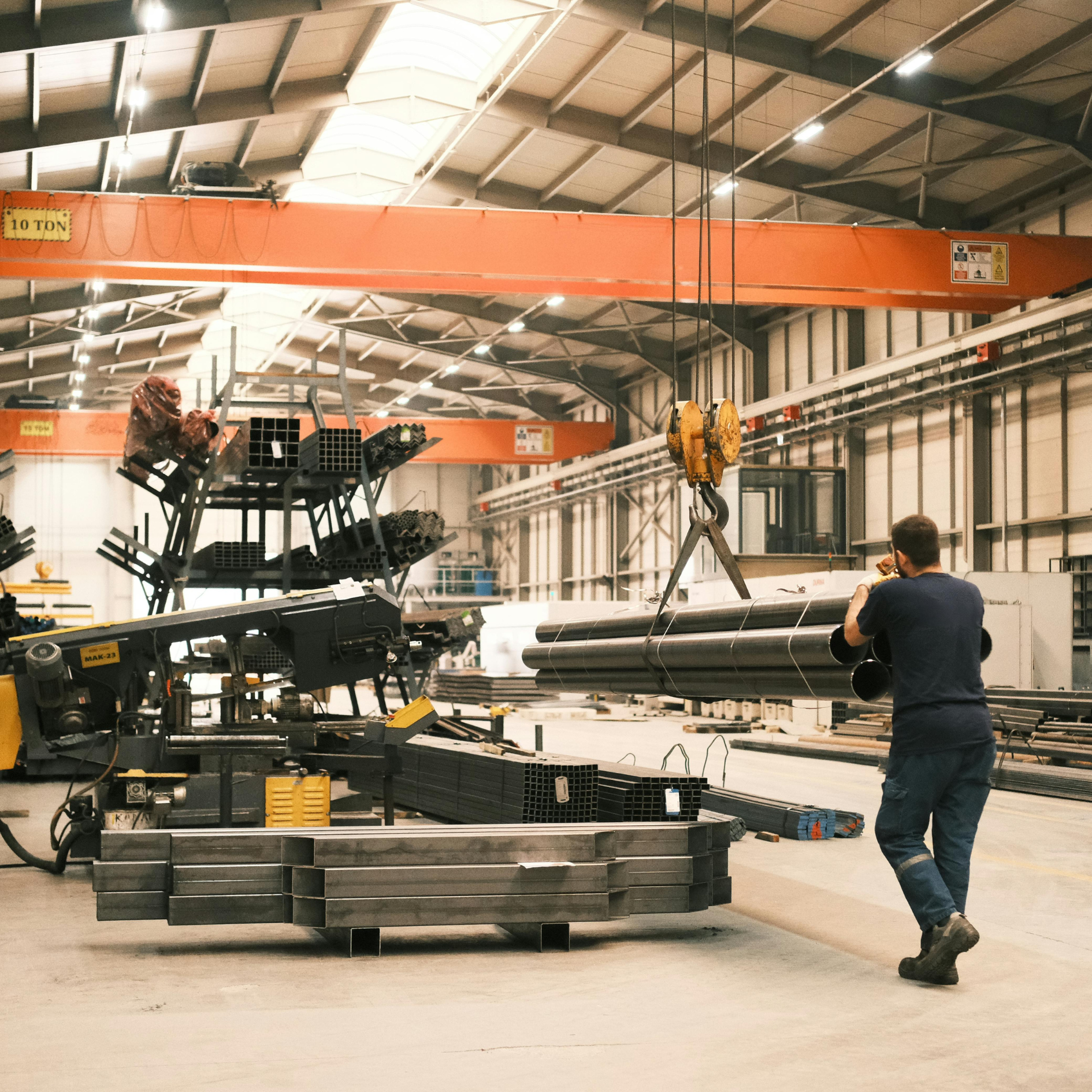 Consistent Results A light industrial staffing hire wheeling materials around a warehouse.
